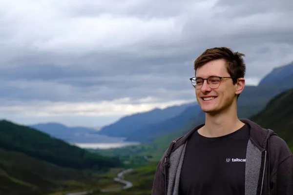 Eli Bosley in front of a mountain valley