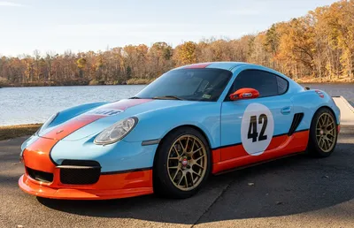 The Gulf-liveried Cayman beside an autumn lake
